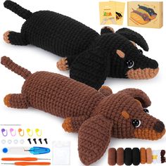 two crocheted dogs laying next to each other with sewing tools and thread spools