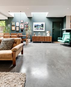 a living room filled with furniture and a skylight over the top of it's windows