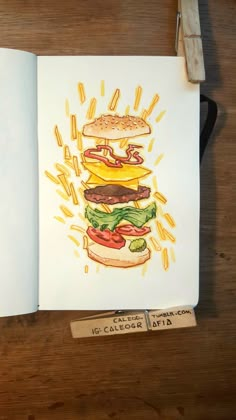 an open notebook with a drawing of a hamburger on it