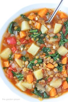 a white bowl filled with soup and vegetables