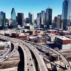 an aerial view of a highway and city skyline