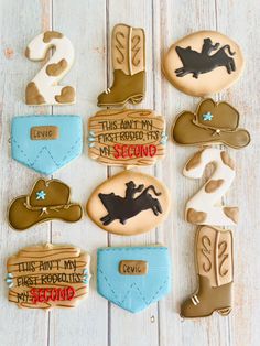 cowboy themed cookies are arranged on a white wooden table with the words, this isn't my first rodeo it's second round