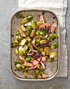 brussel sprouts with apples and cranberries in a baking dish