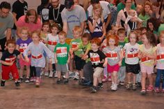 a group of young children standing next to each other