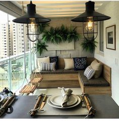 a living room filled with lots of furniture and plants on top of the windowsill