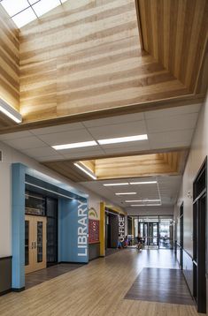 an empty library with wooden floors and skylights