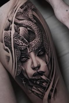 a woman with a snake tattoo on her thigh is shown in black and grey ink