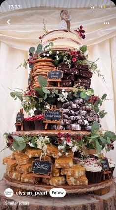 a wedding cake made out of cupcakes and pastries on a tree stump