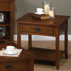 a small wooden table with a coffee cup on it