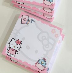 two hello kitty notepads are shown on a white surface with pink trimming