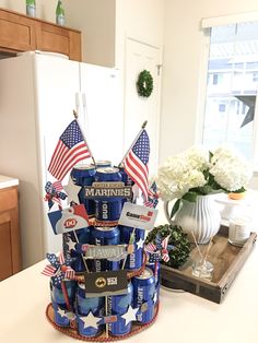 a cake made to look like a stack of beer cans with flags on top and the words marines written on them