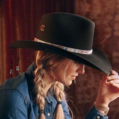 “Through barbed-wire valleys and overgrown dells,” the Wild Horses Hat in Black is blazin’ a trail. Part of our Charlie 1 Horse by Lainey Wilson Collection, this hat comes in a 3 3/4" brim with a full-heart cut-out pattern. The handmade hatband features textured Southwestern patterning. A beaded tassel with an attached feather adds a daisy-like splash of beauty and style. A Dri-Lex sweatband adds a layer of comfort and wearability. Get the Wild Horses in a sleek, eye-catching shade of black. Lai Western Hat Styles, Cowgirl Closet, Charlie Horse, Lainey Wilson, Classy Cowgirl, Closet Clothes, Country Lifestyle, Scarf Headband, Style Upgrade