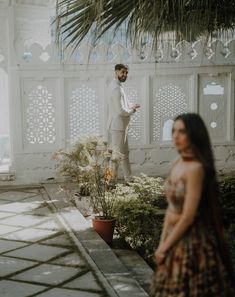 a man standing next to a woman in a dress