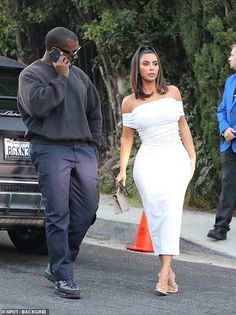 a man and woman walking down the street