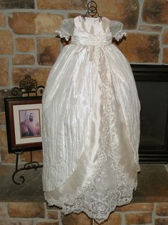 a white dress on display in front of a fireplace