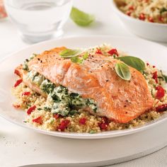 a white plate topped with salmon and rice