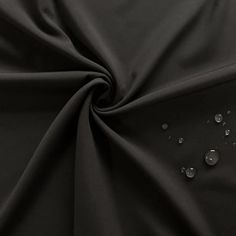 black fabric with drops of water on the top and bottom, as well as an image of