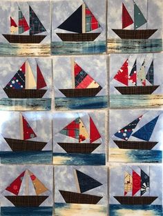 the sailboats are all different colors on the quilted wall hanging in front of the window