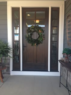 a front door with a wreath on it