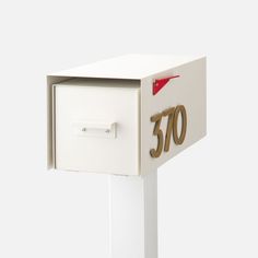 a white mailbox with the number seventy on it