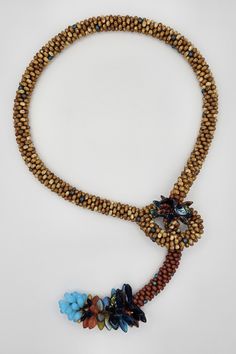 Beaded Necklace - Resembling calico corn, this crocheted lariat ends in a variety of richly-colored Czech glass beads that form a cluster of eggs, leaves, and daggers.  A fringe of similar Czech beads further up the rope anchors the piece in place, which measures 18 around the neck and 26 end to end. Calico Corn, Beautiful Mosaics, Artful Home, Czech Beads, Lariat Necklace, Jewelry Patterns, Bead Weaving, Czech Glass Beads, Anchors