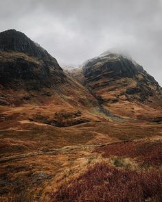 the mountains are covered in brown grass