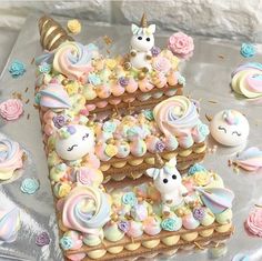 there is a cake with unicorn decorations on it