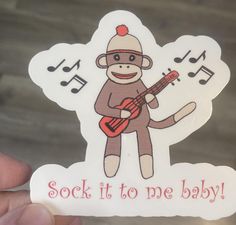 a sticker that says sock it to me baby with a monkey playing the guitar