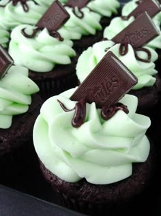 chocolate cupcakes with white frosting and an oreo wrapper on top