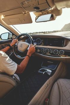 a man driving a car on the road