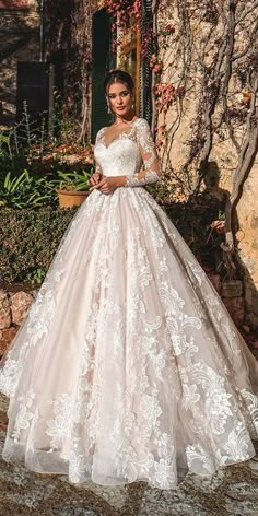 a woman in a wedding dress standing outside