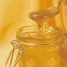 a jar filled with honey sitting on top of a table