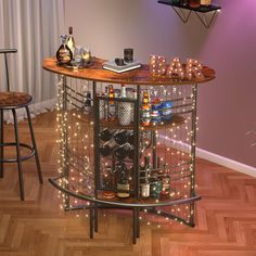 a bar cart with bottles and glasses on it in the corner of a living room