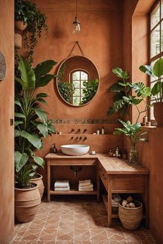 a bath room with a sink a mirror and potted plants