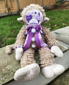 a stuffed animal sitting on top of a stone wall