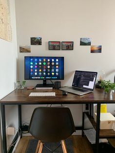 a desk with two computer monitors and a laptop on it