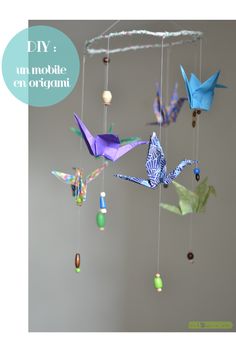 an origami mobile with birds hanging from it's sides and the words diy on top