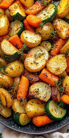 a pan filled with roasted vegetables on top of a table