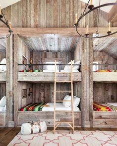 an open book with wooden bunk beds and ladders on the bottom floor, in front of a white rug