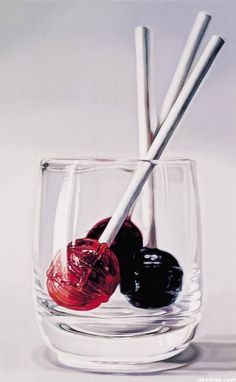 an oil painting of some liquid in a glass with two spoons sticking out of it