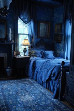 a bed sitting in a bedroom next to a window covered in blue sheets and curtains