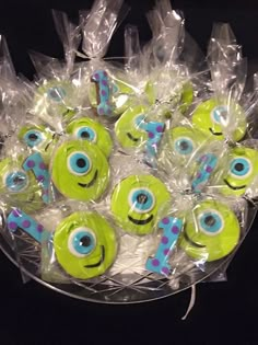 a bunch of green and blue eyeballs in a plastic container