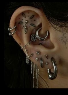 a woman with many different piercings on her ear