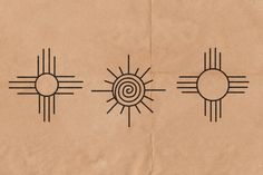 the sun and two circles are drawn on brown paper