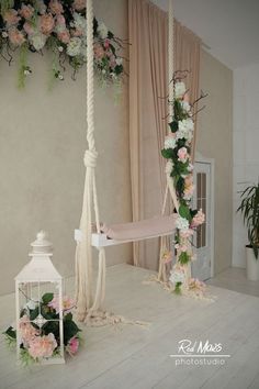 a white hammock with pink and white flowers hanging from it