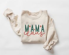 Mama Claus Sweatshirt, Mom Christmas Sweatshirt, Mama Claus Shirt, Mama Christmas Shirt, Mom Christmas Gift, Mama Sweater, Xmas Crewneck  This crewneck sweatshirt is pure comfort. Made from a soft cotton/poly blend with no itchy side seams, this is sure to become a staple. SIZE AND FIT: Your sweatshirt design will be printed on a high-quality, soft and comfortable unisex sweatshirt. Sizes run true to size, which takes the guesswork out of ordering; if you like your sweatshirts loose or oversized, you might want to order a size up and if you'd like a more fitted women's style then order a size down. Sizes range from S - 3X. Please refer to our size chart in the photos for exact dimensions. DETAILS AND FABRIC: * 50% Cotton 50% Polyester * Medium-heavy fabric (8.0 oz/yd² (271.25 g/m * Loose U Christmas Festive Cotton Sweatshirt, Festive Christmas Cotton Sweatshirt, Holiday Cotton Sweatshirt With Letter Print, Christmas Gift Cotton Sweater, Elsa Shirt, Mama Sweater, Nurse Christmas, Christmas Crewneck, Christmas Tops