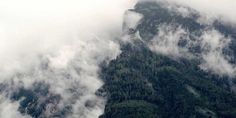 the top of a mountain covered in clouds