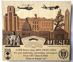 a wooden plaque with an image of the us capitol building and two airplanes flying over it