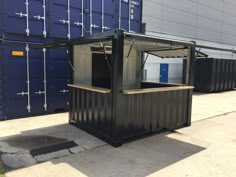 an outdoor kiosk made out of shipping containers