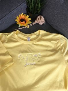 Beautiful heather yellow cotton t-shirt embroidered with Jesus flowers White T-shirt With Embroidered Logo For Spring, Casual Yellow Embroidered T-shirt, Relaxed Fit T-shirt With Embroidered Logo For Summer, Yellow Cotton Top With Embroidered Logo, Casual Yellow T-shirt With Embroidered Graphics, White Tops With Embroidered Logo For Spring, Casual Yellow Tops With Embroidered Graphics, Casual Yellow Top With Floral Embroidery, Embroidered Cotton Tops For Spring